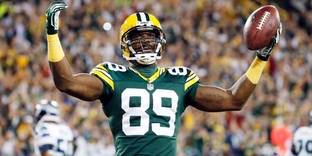 The Green Bay Packers' James Jones celebrates a touchdown catch during the first half of an NFL football game against the Seattle Seahawks on Sunday, Sept. 20, 2015, in Green Bay, Wis.