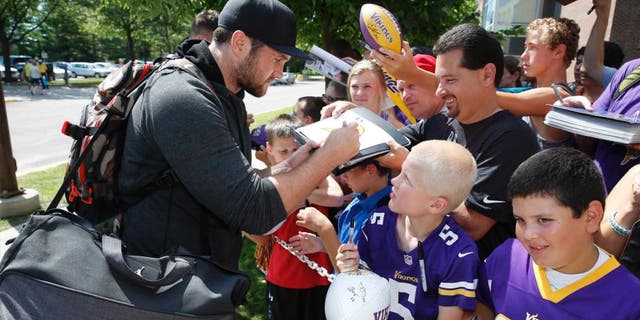 Minnesota Vikings linebacker Casey Matthews signs autographs as he reports to training camp on the campus of Minnesota State University, Saturday, July 25, 2015, in Mankato.
