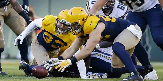 The Green Bay Packers' Clay Matthews recovers a fumble by the San Diego Chargers' Melvin Gordon during the first half Sunday, Oct. 18, 2015, in Green Bay, Wis.