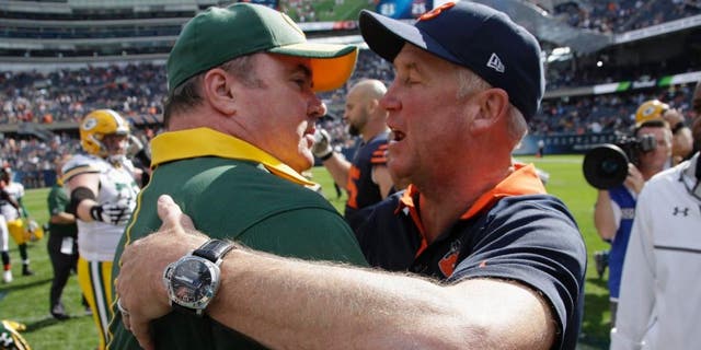 Green Bay Packers head coach Mike McCarthy and Chicago Bears head coach John Fox talk after their NFL football game, Sunday, Sept. 13, 2015, in Chicago. The Packers won 31-23.