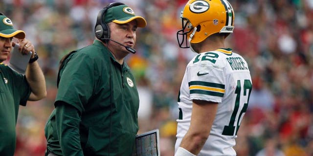 Dec 21, 2014; Tampa, FL, USA; Green Bay Packers head coach Mike McCarthy talks with quarterback Aaron Rodgers (12) against the Tampa Bay Buccaneers during the second half at Raymond James Stadium. Green Bay Packers defeated the Tampa Bay Buccaneers 20-3. Mandatory Credit: Kim Klement-USA TODAY Sports
