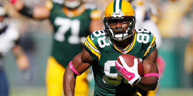 The Green Bay Packers' Ty Montgomery catches a touchdown pass during the first half against the St. Louis Rams on Sunday, Oct. 11, 2015, in Green Bay, Wis.