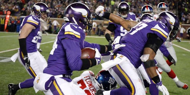 Minnesota Vikings cornerback Captain Munnerlyn runs with his interception of a pass from New York Giants quarterback Eli Manning during the second half Sunday, Dec. 27, 2015, in Minneapolis.