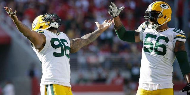Green Bay Packers defensive tackle Mike Neal (left) and outside linebacker Julius Peppers celebrate during the second half against the San Francisco 49ers in Santa Clara, Calif., on Sunday, Oct. 4, 2015. The Packers won 17-3.
