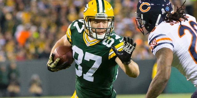 Nov 9, 2014; Green Bay, WI, USA; Green Bay Packers wide receiver Jordy Nelson (87) prepares to stiff arm Chicago Bears cornerback Tim Jennings (26) after catching a pass during the first quarter at Lambeau Field. Mandatory Credit: Jeff Hanisch-USA TODAY Sports