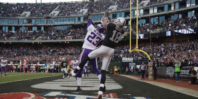 Minnesota Vikings cornerback Terence Newman intercepts the football intended for Oakland Raiders wide receiver Andre Holmes during the fourth quarter at O.co Coliseum in Oakland, Calif., on Sunday, Nov. 15, 2015.