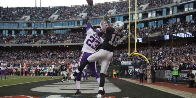 Minnesota Vikings cornerback Terence Newman intercepts the football intended for Oakland Raiders wide receiver Andre Holmes during the fourth quarter at O.co Coliseum in Oakland, Calif., on Sunday, Nov. 15, 2015.