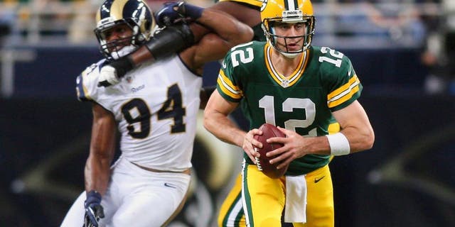 Oct 21, 2012; St. Louis, MO, USA; Green Bay Packers quarterback Aaron Rodgers (12) scrambles against the St. Louis Rams during the second half at Edward Jones Dome. The Packers defeated the Rams 30-20. Mandatory Credit: Scott Kane-USA TODAY Sports