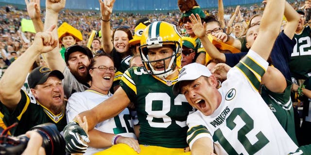 Green Bay Packers' Jeff Janis celebrates his touchdown catch with fans during the first half of an NFL preseason football game against the New Orleans Saints Thursday, Sept. 3, 2015, in Green Bay, Wis. (AP Photo/Mike Roemer)