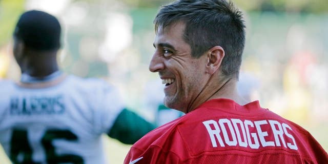 Green Bay Packers' Aaron Rodgers smiles during NFL football minicamp, Tuesday, June 16, 2015, in Green Bay, Wis. (AP Photo/Morry Gash)