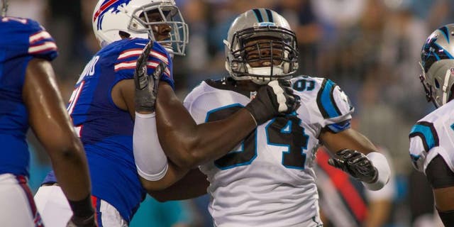 Aug 8, 2014; Charlotte, NC, USA; Carolina Panthers defensive end Kony Ealy (94) gets blocked by Buffalo Bills offensive tackle Cyrus Kouandjio (71) during the third quarter at Bank of America Stadium. Buffalo defeated Carolina 20-18. Mandatory Credit: Jeremy Brevard-USA TODAY Sports