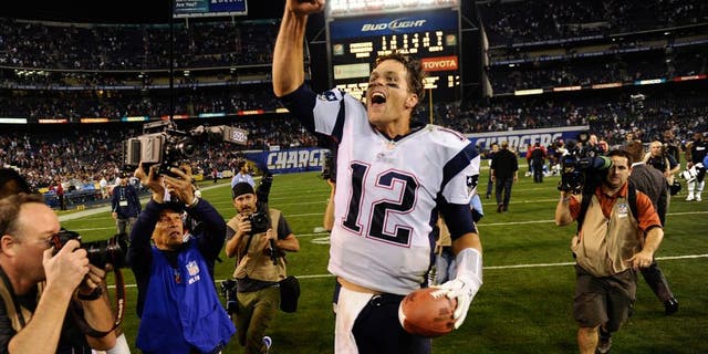 Dec 7, 2014; San Diego, CA, USA; New England Patriots quarterback Tom Brady (12) celebrates his teams 23-14 win over the San Diego Chargers at Qualcomm Stadium. Mandatory Credit: Robert Hanashiro-USA TODAY Sports
