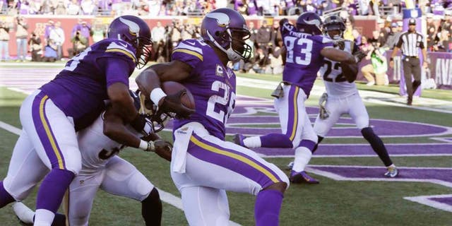 Minnesota Vikings running back Adrian Peterson gets into the end zone with a 6-yard run for a touchdown during the first half against the St. Louis Rams on Sunday, Nov. 8, 2015, in Minneapolis.