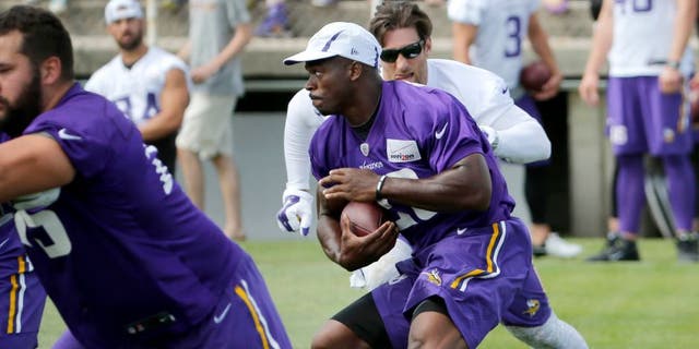 Sunday, July 26: Minnesota Vikings running back Adrian Peterson carries the ball during practice training camp on the campus of Minnesota State University in Mankato.