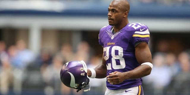Nov 3, 2013; Arlington, TX, USA; Minnesota Vikings running back Adrian Peterson (28) with his helmet off returns to the huddle against the Dallas Cowboys at AT&T Stadium. Mandatory Credit: Matthew Emmons-USA TODAY Sports