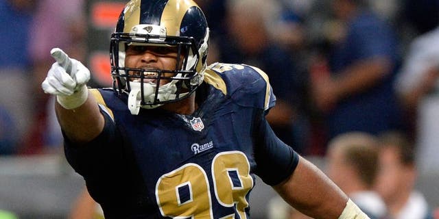 Sep 13, 2015; St. Louis, MO, USA; St. Louis Rams defensive tackle Aaron Donald (99) celebrates after sacking Seattle Seahawks quarterback Russell Wilson (not pictured) during the second half at the Edward Jones Dome. The Rams defeated the Seahawks 34-31 in overtime. Mandatory Credit: Jeff Curry-USA TODAY Sports
