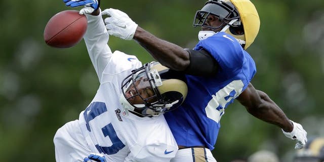 St. Louis Rams cornerback Marcus Roberson, left, knocks a pass away from wide receiver Brian Quick during training camp at the NFL football team's practice facility Tuesday, Aug. 4, 2015, in St. Louis. (AP Photo/Jeff Roberson)