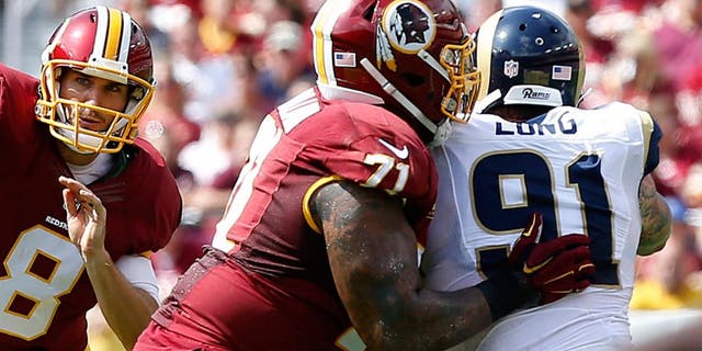 Sep 20, 2015; Landover, MD, USA; Washington Redskins quarterback Kirk Cousins (8) throws the ball as St. Louis Rams defensive end Chris Long (91) chases in the first quarter at FedEx Field. Mandatory Credit: Geoff Burke-USA TODAY Sports