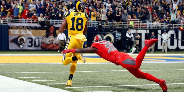St. Louis Rams wide receiver Kenny Britt, left, heads for the end zone on a 60-yard touchdown reception as Tampa Bay Buccaneers cornerback Jude Adjei-Barimah defends during the first quarter of an NFL football game Thursday, Dec. 17, 2015, in St. Louis. (AP Photo/Billy Hurst)