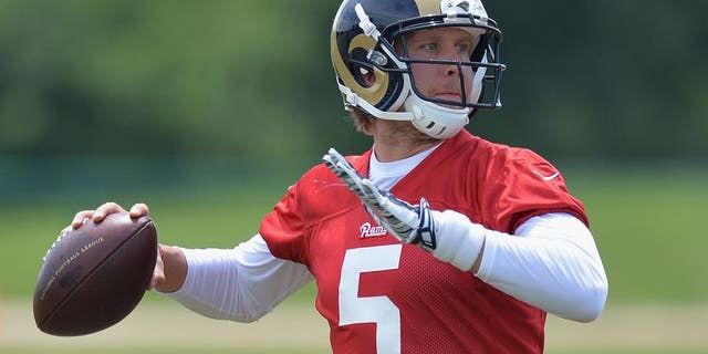 St. Louis Rams quarterback Nick Foles throws a pass during an NFL football organized team activity, Thursday, June 11, 2015, in St. Louis. (AP Photo/Michael Thomas)