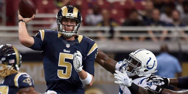 St. Louis Rams quarterback Nick Foles, left, throws under pressure from Indianapolis Colts linebacker Trent Cole during the first quarter of an NFL preseason football game Saturday, Aug. 29, 2015, in St. Louis. (AP Photo/L.G. Patterson)