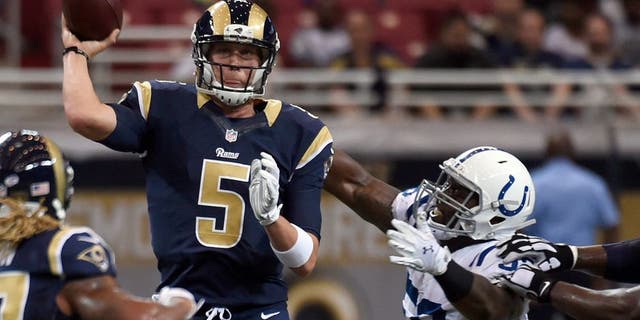 St. Louis Rams quarterback Nick Foles, left, throws under pressure from Indianapolis Colts linebacker Trent Cole during the first quarter of an NFL preseason football game Saturday, Aug. 29, 2015, in St. Louis. (AP Photo/L.G. Patterson)