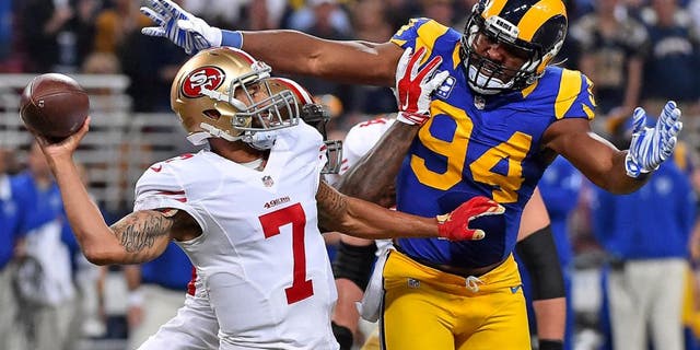 Nov 1, 2015; St. Louis, MO, USA; St. Louis Rams defensive end Robert Quinn (94) pressures San Francisco 49ers quarterback Colin Kaepernick (7) during the first half at the Edward Jones Dome. Mandatory Credit: Jasen Vinlove-USA TODAY Sports