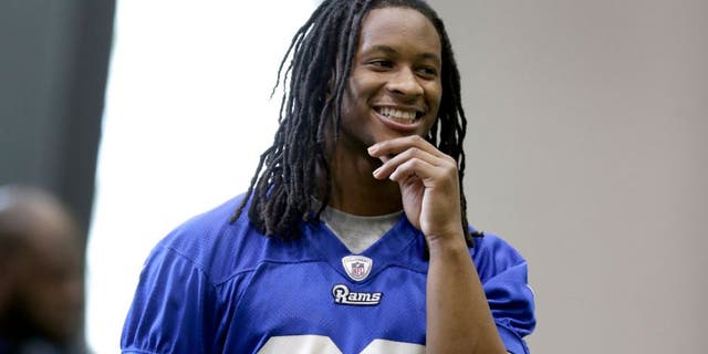 St Louis Rams first-round draft pick, running back Todd Gurley, smiles as he stands on the sideline during a rookie minicamp at the NFL football team's practice facility Friday, May 8, 2015, in St. Louis. (AP Photo/Jeff Roberson)
