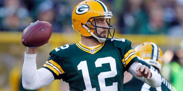 The Green Bay Packers' Aaron Rodgers throws during the first half of an NFL football game against the Detroit Lions on Sunday, Nov. 15, 2015, in Green Bay, Wis.