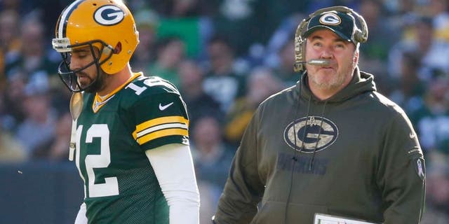 Green Bay Packers head coach Mike McCarthy talks to quarterback Aaron Rodgers during the first half of an NFL football game against the Detroit Lions on Sunday, Nov. 15, 2015, in Green Bay, Wis.