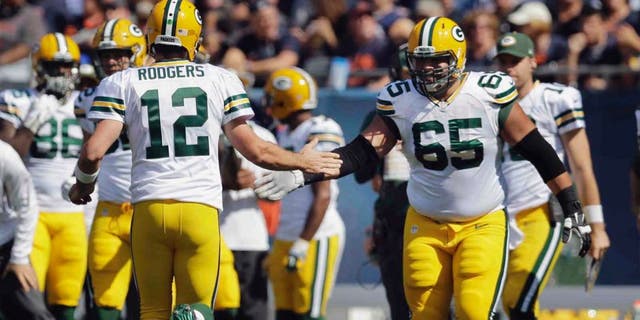 Green Bay Packers quarterback Aaron Rodgers (left) celebrates with guard Lane Taylor after throwing a touchdown pass in the first half.