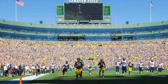 Green Bay Packers cornerback Quinten Rollins returns an interception for a touchdown in the first quarter against the St. Louis Rams at Lambeau Field in Green Bay, Wis., on Sunday, Oct. 11, 2015.