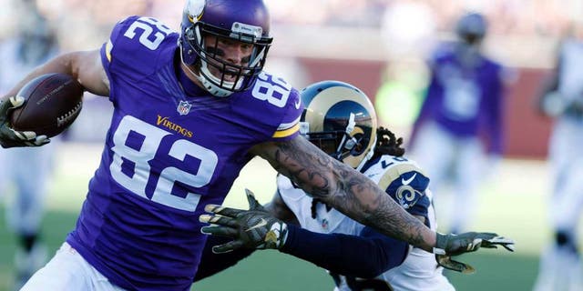 Minnesota Vikings tight end Kyle Rudolph is pulled down by St. Louis Rams outside linebacker Mark Barron during the first half on Sunday, Nov. 8, 2015, in Minneapolis.