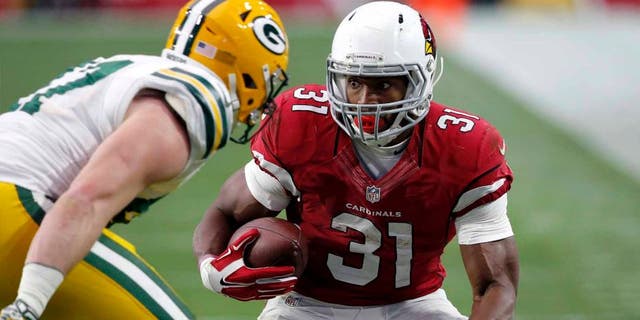 Arizona Cardinals running back David Johnson tries to elude Green Bay Packers outside linebacker Jake Ryan during the first half Sunday, Dec. 27, 2015, in Glendale, Ariz.