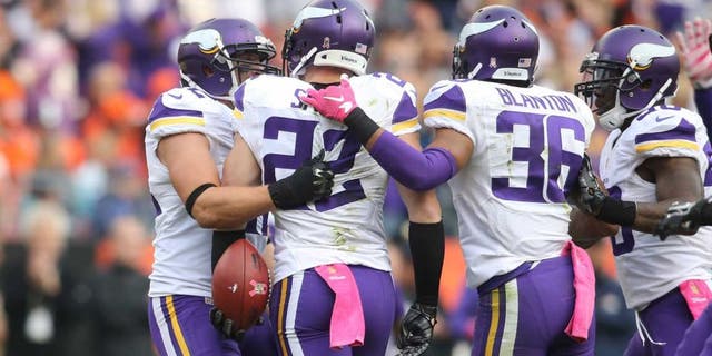 Minnesota Vikings free safety Harrison Smith celebrates with teammates after intercepting a pass intended for Denver Broncos wide receiver Demaryius Thomas during the second half at Sports Authority Field at Mile High in Denver on Sunday, Oct. 4, 2015.