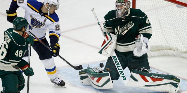 Minnesota Wild goalie Devan Dubnyk (40) deflects a shot by St. Louis Blues left wing Alexander Steen (20) in front of Wild defenseman Jared Spurgeon (46) during the first period of an NHL hockey game in St. Paul, Minn., Saturday, Oct. 10, 2015. (AP Photo/Ann Heisenfelt)