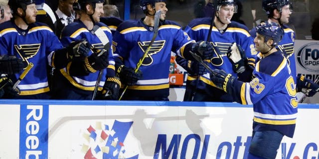 St. Louis Blues' Scott Gomez (93) celebrates with teammates after scoring in the first period of an NHL hockey game against the Tampa Bay Lightning, Tuesday, Oct. 27, 2015 in St. Louis. (AP Photo/Tom Gannam)
