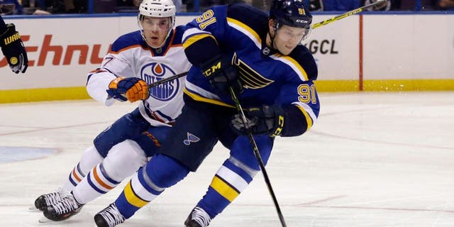 St. Louis Blues' Vladimir Tarasenko, right, of Russia, controls the puck as Edmonton Oilers' Connor McDavid, left, pursues during the first period of an NHL hockey game Thursday, Oct. 8, 2015, in St. Louis. (AP Photo/Jeff Roberson)
