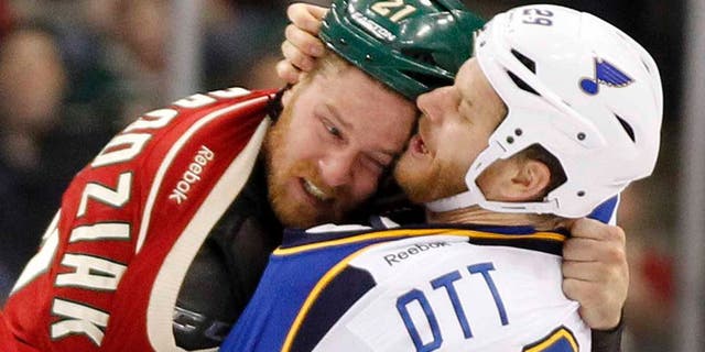 Minnesota Wild center Kyle Brodziak (left) and St. Louis Blues center Steve Ott fight during the first period.