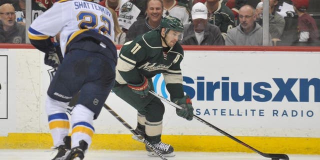 Apr 26, 2015; Saint Paul, MN, USA; Minnesota Wild forward Zach Parise (right) carries into the Blues zone defended by Saint Louis Blues defenseman Kevin Shattenkirk during the second period in Game 6 of the first round of the 2015 Stanley Cup Playoffs at Xcel Energy Center.