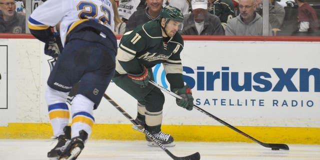 Apr 26, 2015; Saint Paul, MN, USA; Minnesota Wild forward Zach Parise (right) carries into the Blues zone defended by Saint Louis Blues defenseman Kevin Shattenkirk during the second period in Game 6 of the first round of the 2015 Stanley Cup Playoffs at Xcel Energy Center.