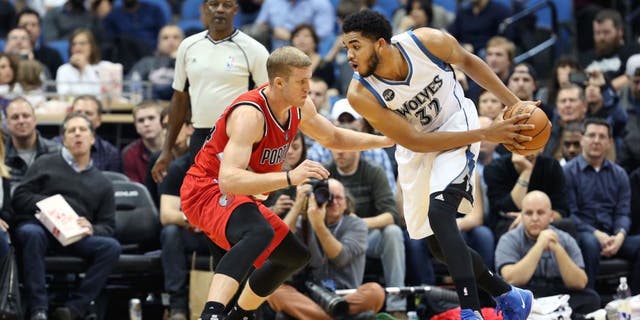 MINNEAPOLIS, MN - DECEMBER 5: Karl-Anthony Towns #32 of the Minnesota Timberwolves defends the ball against the Portland Trail Blazers during the game on December 5, 2015 at Target Center in Minneapolis, Minnesota. NOTE TO USER: User expressly acknowledges and agrees that, by downloading and or using this Photograph, user is consenting to the terms and conditions of the Getty Images License Agreement. Mandatory Copyright Notice: Copyright 2015 NBAE (Photo by Jordan Johnson/NBAE via Getty Images)