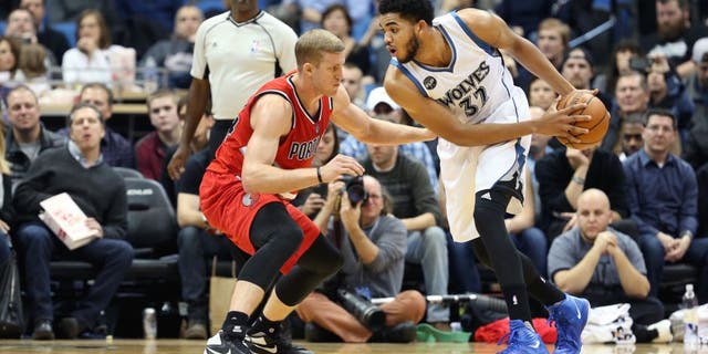 MINNEAPOLIS, MN - DECEMBER 5: Karl-Anthony Towns #32 of the Minnesota Timberwolves defends the ball against the Portland Trail Blazers during the game on December 5, 2015 at Target Center in Minneapolis, Minnesota. NOTE TO USER: User expressly acknowledges and agrees that, by downloading and or using this Photograph, user is consenting to the terms and conditions of the Getty Images License Agreement. Mandatory Copyright Notice: Copyright 2015 NBAE (Photo by Jordan Johnson/NBAE via Getty Images)