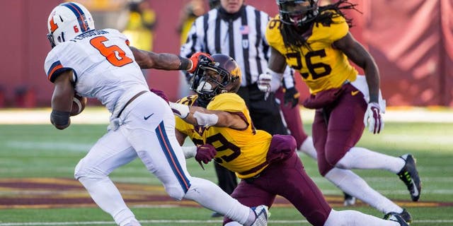 Nov 21, 2015; Minneapolis, MN, USA; Minnesota Golden Gophers defensive back Briean Boddy-Calhoun (29) gets stiff armed by Illinois Fighting Illini running back Josh Ferguson (6) in the second half at TCF Bank Stadium. The Gophers won 32-23. Mandatory Credit: Jesse Johnson-USA TODAY Sports
