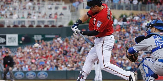 Minnesota Twins' Robbie Grossman hits an RBI double off Toronto Blue Jays pitcher Aaron Sanchez in the second inning of a baseball game Friday, May 20, 2016, in Minneapolis. (AP Photo/Jim Mone)
