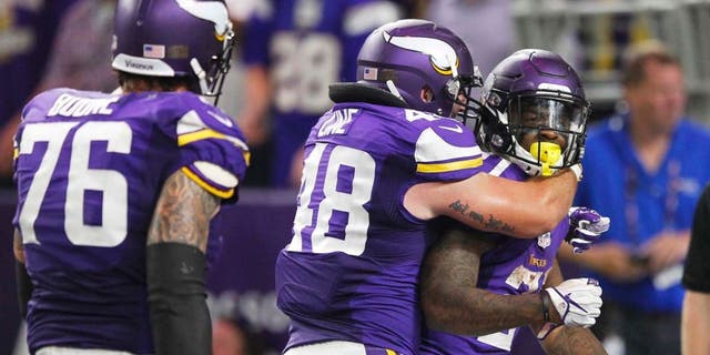 Minnesota Vikings running back Jerick McKinnon, right, celebrates with teammates Zach Line, center, and Alex Boone, left, after scoring on a 4-yard touchdown run during the second half of an NFL football game against the New York Giants, Monday, Oct. 3, 2016, in Minneapolis. (AP Photo/Andy Clayton-King)