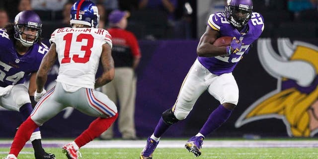 Minnesota Vikings cornerback Xavier Rhodes, right, runs from New York Giants wide receiver Odell Beckham (13) after intercepting a pass during the second half of an NFL football game Monday, Oct. 3, 2016, in Minneapolis. (AP Photo/Andy Clayton-King)
