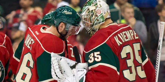 Dec 15, 2015; Saint Paul, MN, USA; Minnesota Wild forward Thomas Vanek (26) and goalie Darcy Kuemper (35) celebrate the win after the game against the Vancouver Canucks at Xcel Energy Center. The Minnesota Wild beat the Vancouver Canucks 6-2. Mandatory Credit: Brad Rempel-USA TODAY Sports