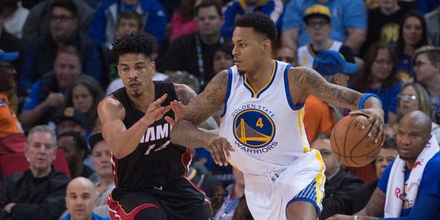 January 11, 2016; Oakland, CA, USA; Golden State Warriors forward Brandon Rush (4) dribbles the basketball against Miami Heat forward Gerald Green (14) during the second quarter at Oracle Arena. The Warriors defeated the Heat 111-103. Mandatory Credit: Kyle Terada-USA TODAY Sports