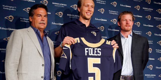 Nick Foles, center, is introduced as the new St. Louis Rams quarterback by Rams head coach Jeff Fisher, left, and general manger Les Snead, right, during an NFL fooball news conference Friday, March 13, 2015, in St. Louis. Foles was traded to the Rams earlier this week, with Sam Bradford going to the Philadelphia Eagles in a quarterback swap. (AP Photo/Jeff Roberson)
